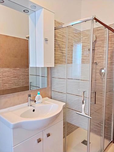 a bathroom with a sink and a shower at Trilocale vacanza Riccione in Riccione