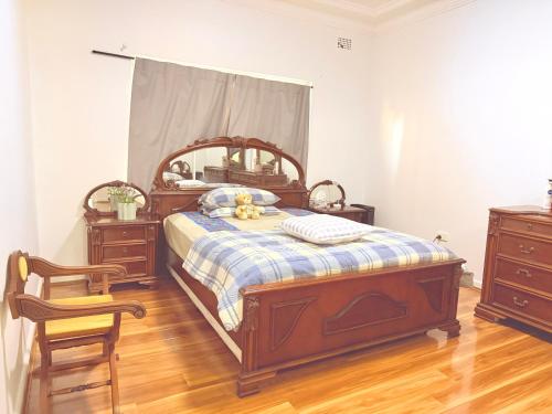 a bedroom with a bed with a teddy bear on it at Spacious Luxe Rooms - Prime location in Earlwood & close to shops in Sydney