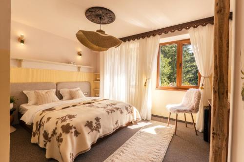 a bedroom with a bed and a window and a clock at Kuker Hut - Хижа Кукер in Sofia