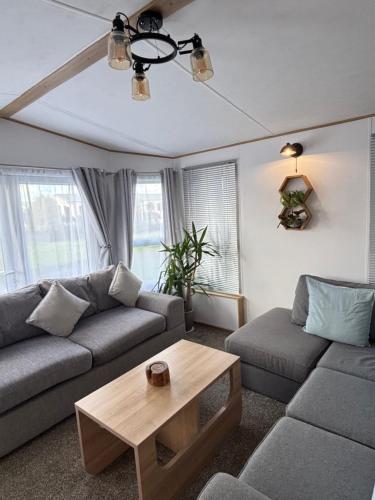 a living room with a couch and a coffee table at Seven Bays Hideaway in St Merryn