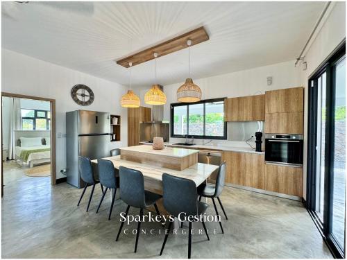a kitchen and dining room with a table and chairs at SG19 Villa Serenity Lux in Calodyne