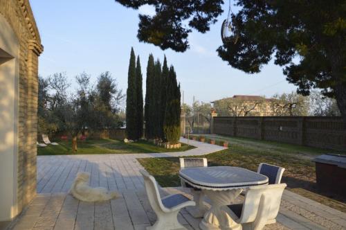 a patio with a table and chairs in a yard at Le Tre Lune B&B in Lucera