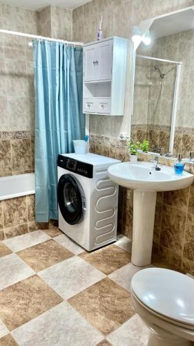 a washing machine in a bathroom next to a sink at Casa MªÁngeles in Puebla de Arenoso