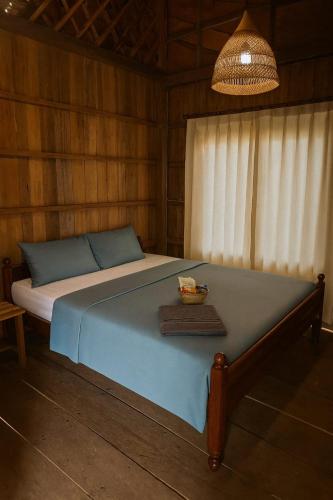 En eller flere senge i et værelse på Gecko Guesthouse