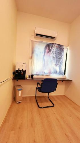 a chair in a room with a painting on the wall at D Cloud Homestay & Room in Kajang
