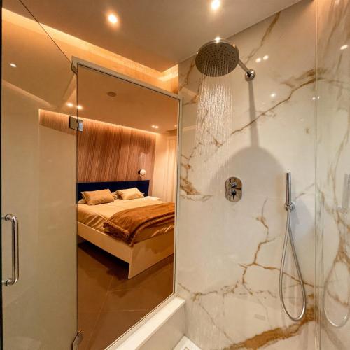 a bathroom with a shower and a bed in a room at Le Due Muse b&b in Pagani