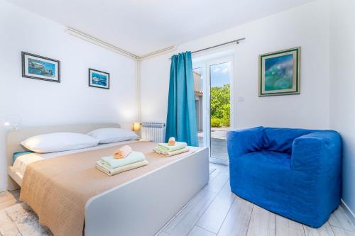 En eller flere senge i et værelse på Villa Marin