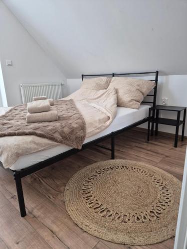 - un lit avec des couvertures et des oreillers dans une chambre dans l'établissement Domek Noclegowy JoWish, à Strachocina