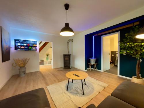 a living room with a couch and a table at Ferien im Schwarzwald Dörlinbach II in Schuttertal