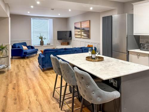a kitchen and living room with a table and chairs at Stone's Throw in Richmond