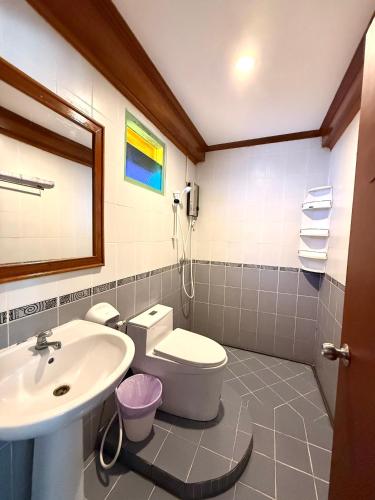 a bathroom with a toilet and a sink at Mr. Black Resort in Haad Rin