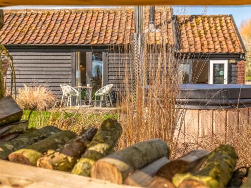 a pile of cucumbers in front of a house at The Cowshed - Uk50803 in Cratfield