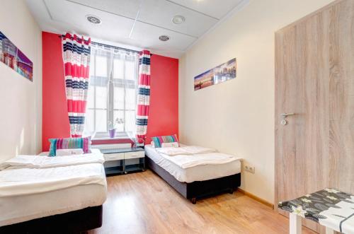 a room with two beds and a window at 3 City Hostel in Gdańsk