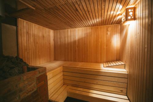 a wooden sauna with a light on top of it at Viesu nams Melnsils in Melnsils
