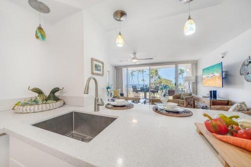 a kitchen with a sink and a counter top at Island Surf 306 · ISF 306 1BD w Ocean Views AC Pool Near Beach in Kihei