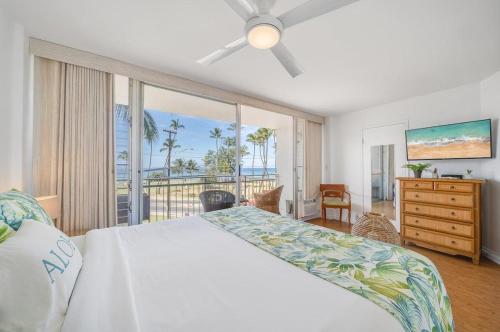 a bedroom with a bed and a view of the ocean at Island Surf 306 · ISF 306 1BD w Ocean Views AC Pool Near Beach in Kihei