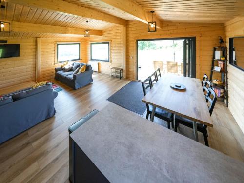 una sala de estar con una mesa y un sofá en Bluebell Lodge - Uk50875, en Hittisleigh