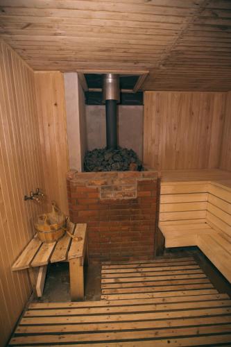 an inside of a sauna with a bench and a stove at Viesu nams Melnsils in Melnsils