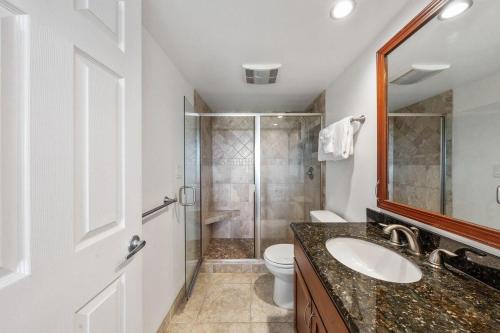 a bathroom with a toilet and a sink and a shower at Maui Banyan P301 · MB P301 Remodeled 2BD Condo Across Beach Pool in Wailea