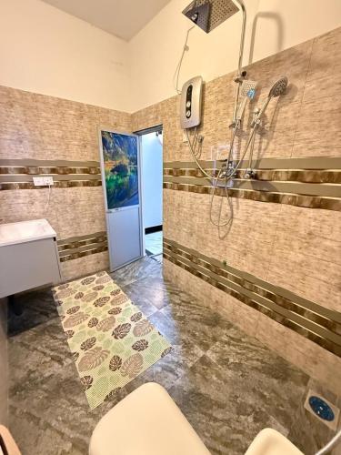 a bathroom with a shower and a sink at New Star Villa in Bentota