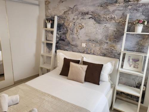 a bedroom with a white bed with two pillows at Villa de Blue 3 in Bol