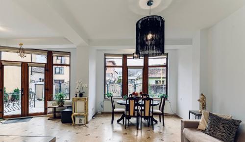 a living room with a table and a dining room at Vila LINA in Braşov