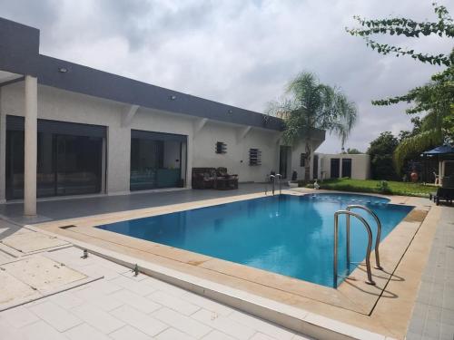 a swimming pool in front of a house at Villa Luxe Fès avec Piscine & Spa, proche aéroport, Private Hammam in Fès