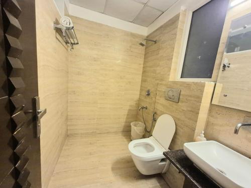 um banheiro com vaso sanitário e pia em Stays - Golf Course Road em Gurgaon