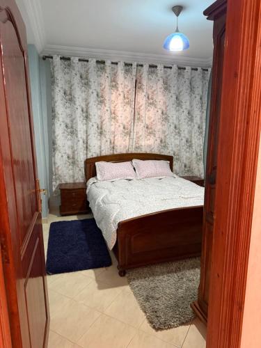 a bedroom with a bed and a window at The perfect Riad Al Salam apartment in Agadir