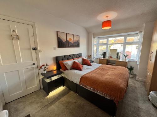 a bedroom with a large bed and a window at Lovely 1-Bed City Centre escape with Kitchen & Free Parking in Spon End