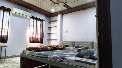 a bedroom with two beds in a room at Modern Guest House in Ujjain