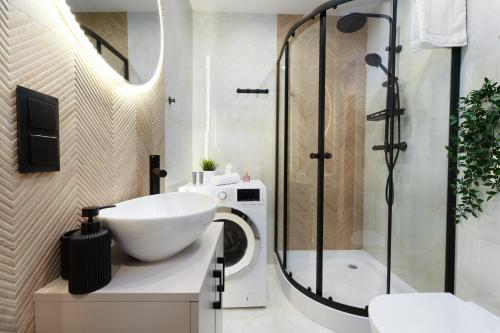 a bathroom with a sink and a shower at Modern Home in Sosnowiec