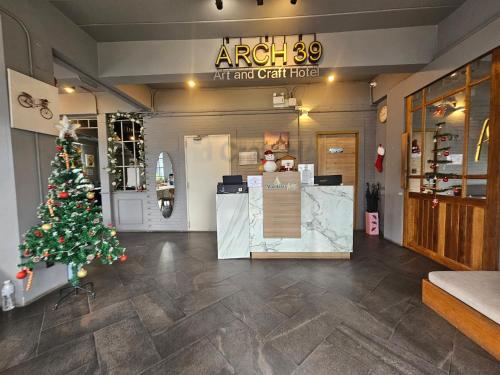 a store with a christmas tree in a room at Mandalar Arch 39 Hotel in Chiang Mai