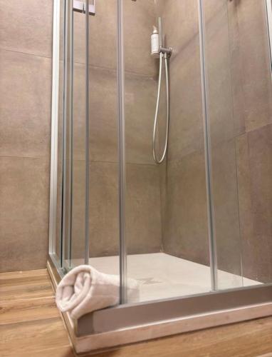 a shower with a glass door in a bathroom at NORA Apartment 2 in Civitanova Marche