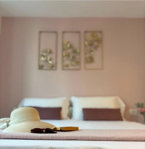 a bedroom with a bed with three pictures on the wall at NORA Apartment 2 in Civitanova Marche