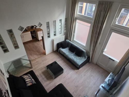 an overhead view of a living room with a couch at Urban Oasis - BIG stylish Apartment in Schiedam