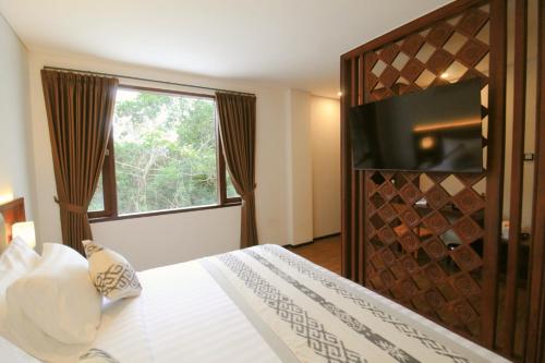 Postel nebo postele na pokoji v ubytování Catra Wellness Hotel Ubud