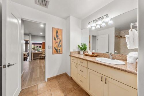 a bathroom with a sink and a mirror at Kaanapali Royal H101 · KRL H101 Remodel 2BD Condo Pool Kaanapali in Kaanapali