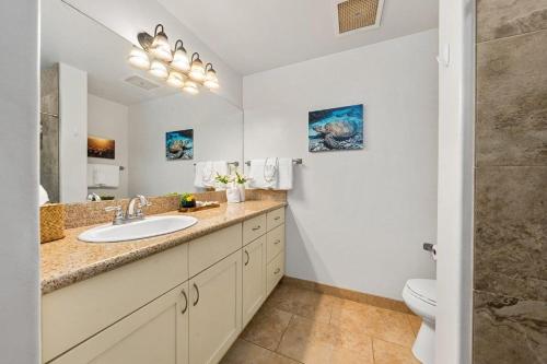 a bathroom with a sink and a toilet at Kaanapali Royal H101 · KRL H101 Remodel 2BD Condo Pool Kaanapali in Kaanapali