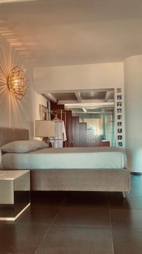a bedroom with a large bed and a chandelier at 202 luxury terrace view in Taormina