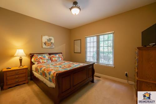 a bedroom with a bed and a dresser and a window at 4BR Walk-in - Foosball Table - Fire Pit - FREE TICKETS INCLUDED - DV166 in Branson