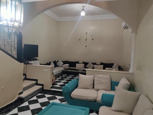 a living room with two couches and a tv at JackRouivo in Marrakech