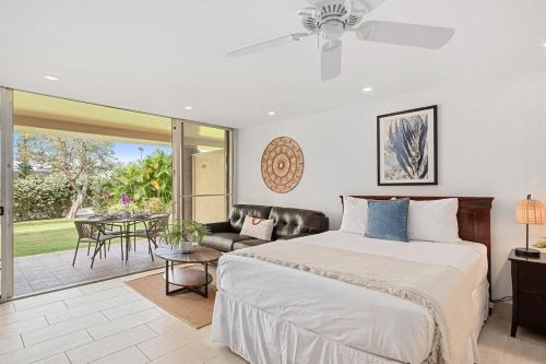 a bedroom with a bed and a patio with a table at Maui Kaanapali Villas 119 · MKV 119 Newly Remodeled Garden View in Kahana