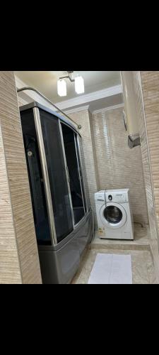 a small caravan with a washing machine in a room at Раззаков in Bishkek