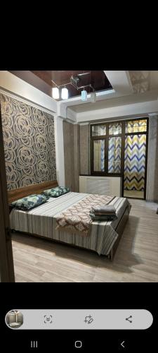 a bedroom with a large bed in a room at Раззаков in Bishkek