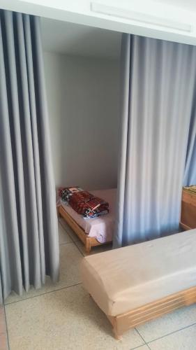 a room with two beds and a curtain at sweet area in Mirleft