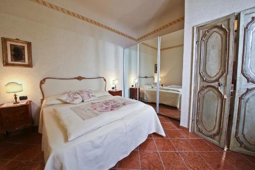 フィレンツェにあるVigna Nuova Lauraのベッドルーム(白いベッド1台、鏡付)