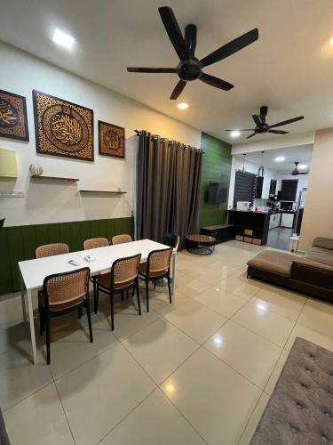 a living room with a table and chairs and a couch at TF Homestay in Banting