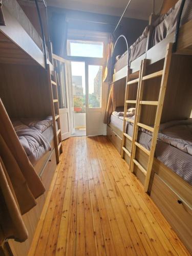 a room with bunk beds and a wooden floor at Bisan hostel in Cairo