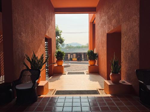 a hallway with potted plants in a building at Las Tortugas beach front condo in Khao Tao